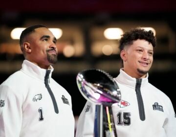 Philadelphia Eagles quarterback Jalen Hurts (1) and Kansas City Chiefs quarterback Patrick Mahomes (15) pose with the Lombardy Trophy during Super Bowl 59 Opening Night, Monday, Feb. 3, 2025, in New Orleans