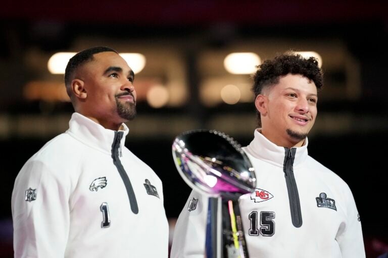 Philadelphia Eagles quarterback Jalen Hurts (1) and Kansas City Chiefs quarterback Patrick Mahomes (15) pose with the Lombardy Trophy during Super Bowl 59 Opening Night, Monday, Feb. 3, 2025, in New Orleans