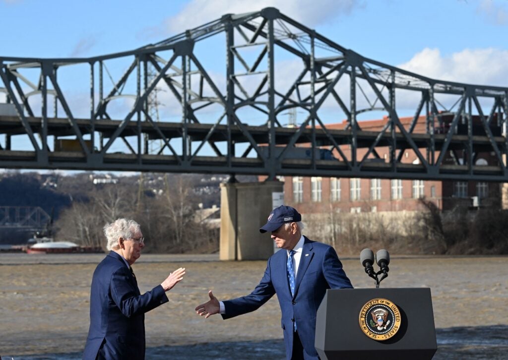 Former President Joe Biden shakes hands with Republican Sen. Mitch McConnell 