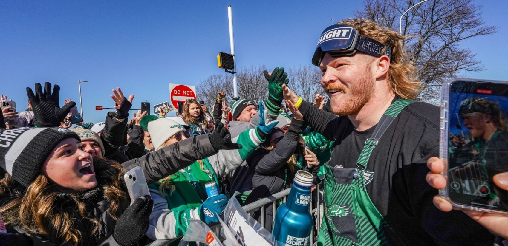 Offensive Lineman Cam Jurgens greets fans on South Broad Street during the Philadelphia Eagles Super Bowl LIX victory parade, Friday Feb. 14, 2025. (For WHYY/ Joseph Kaczmarek)
