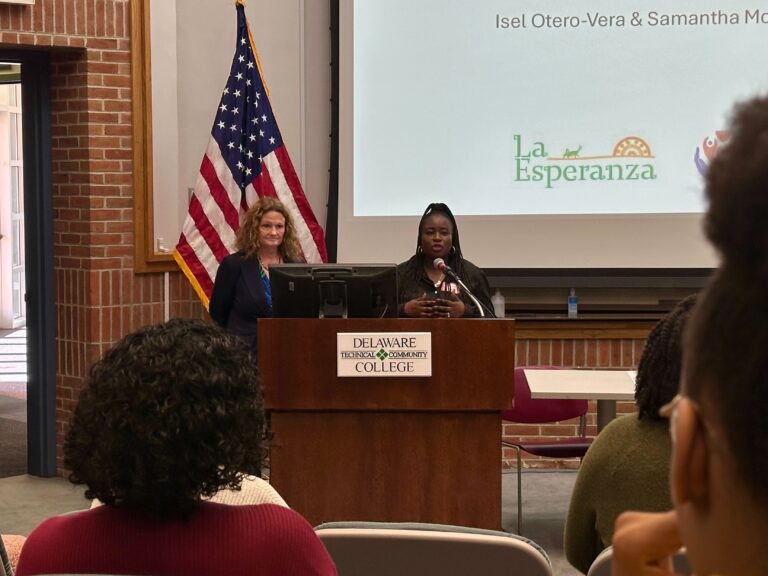 Jennifer, on the left, and Midline, on the right, from La Esperanza presents findings from the Thriving Newcomers Project at Delaware Technical Community College. Their work focuses on addressing the unique challenges faced by Latino and Haitian communities in Sussex County. (Johnny Perez-González/WHYY)