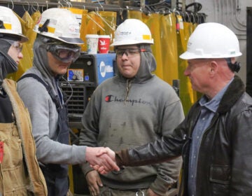 Mark Kelly speaking with factory workers on the tour