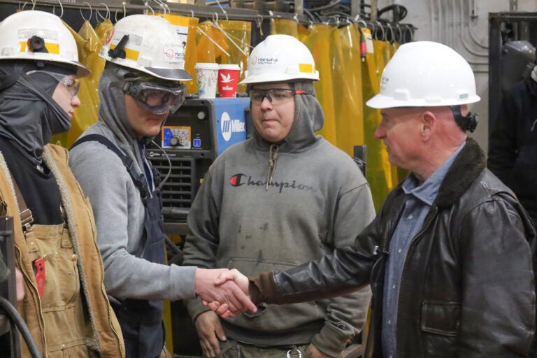 Mark Kelly speaking with factory workers on the tour