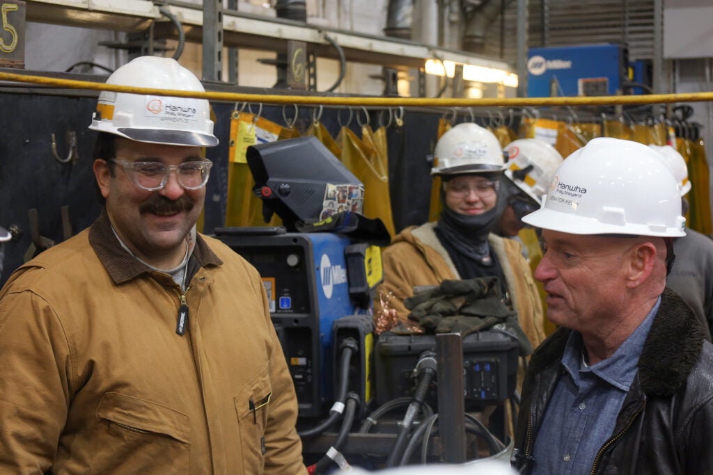 Mark Kelly speaking with factory workers on the tour