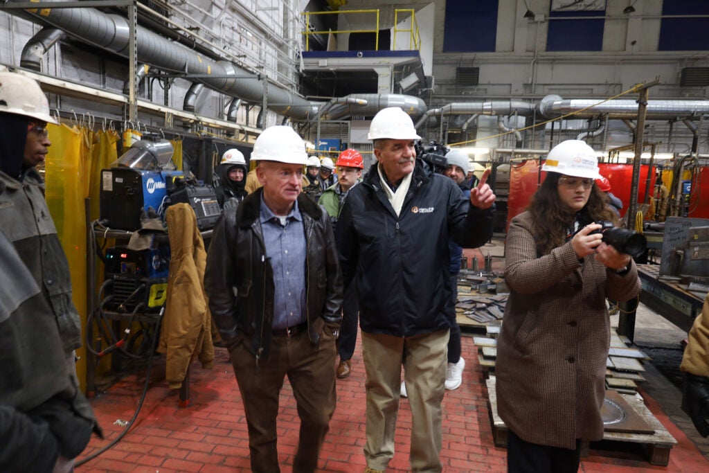 Mark Kelly speaking with factory workers on the tour