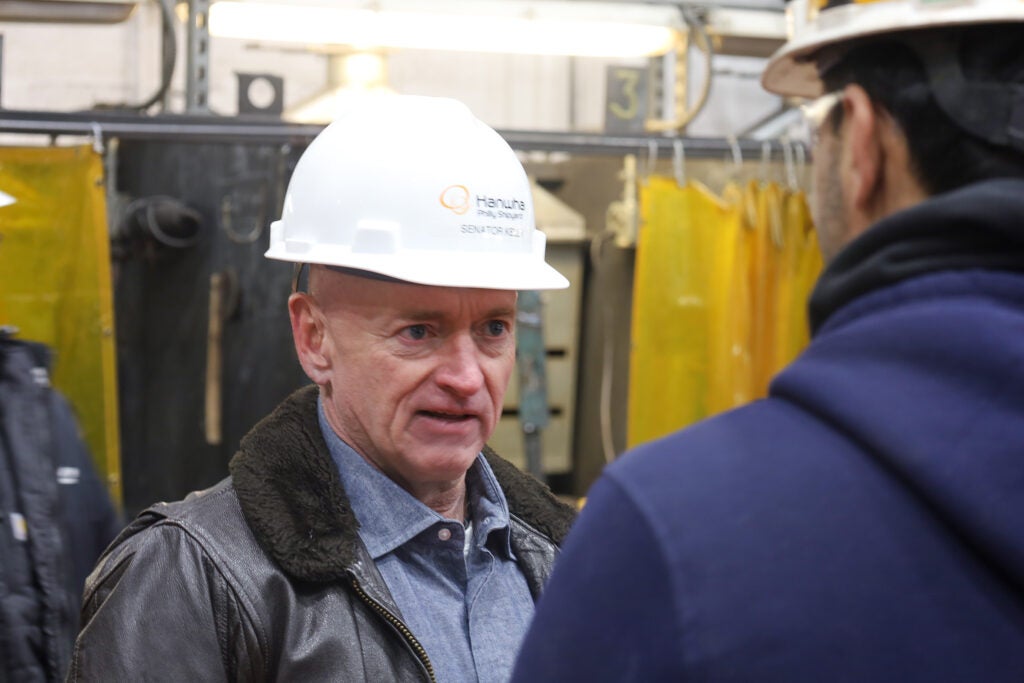 Mark Kelly speaking with factory workers on the tour