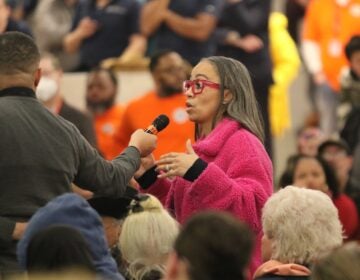 A town hall attendee asks a question following the deadly medical jet crash in Philadelphia.