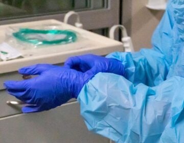 a nurse's hands adjusting gloves