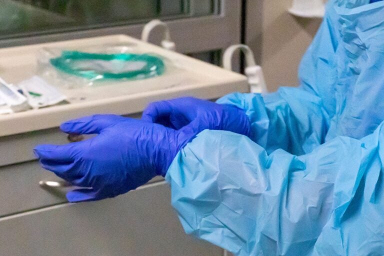 a nurse's hands adjusting gloves