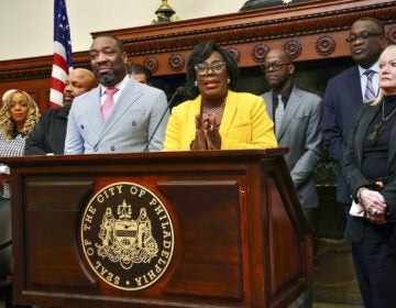 Cherelle Parker speaking at a podium surrounded by other officials