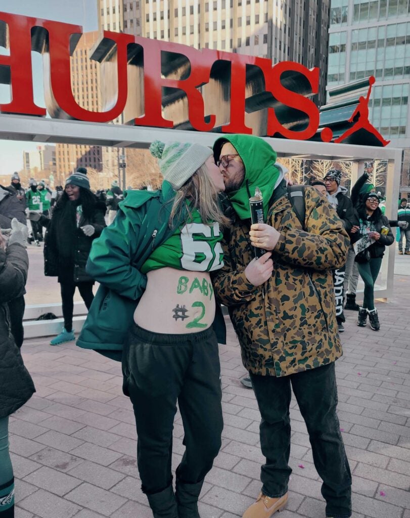 Kim and Steve Rudnet make a baby announcement at Philly's iconic LOVE statue ahead of the Eagles Super Bowl parade.