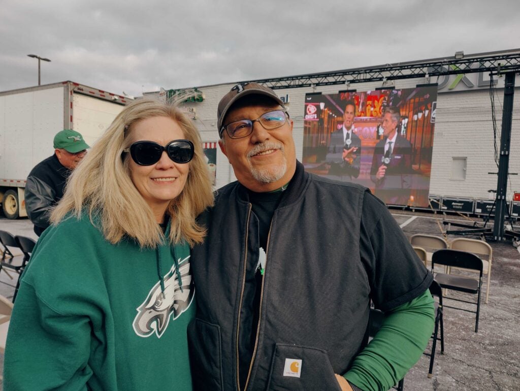 Cindy O'Neill and Pete Sarno wearing their Eagles gear at the tailgate