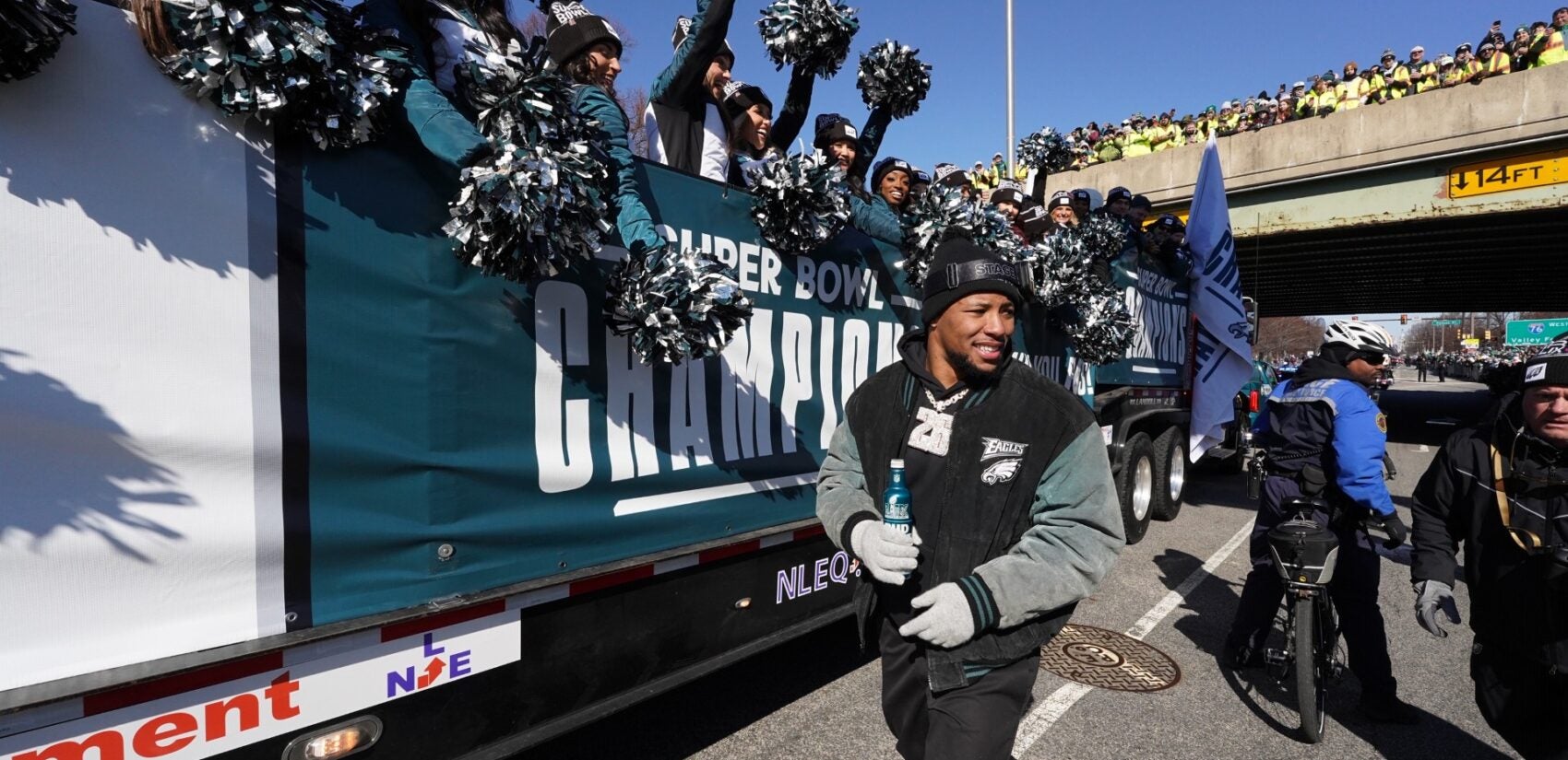 Saquon Barkley greets fans on South Broad Street during the Philadelphia Eagles Super Bowl LIX victory parade, Friday Feb. 14, 2025. (For WHYY/ Joseph Kaczmarek)
