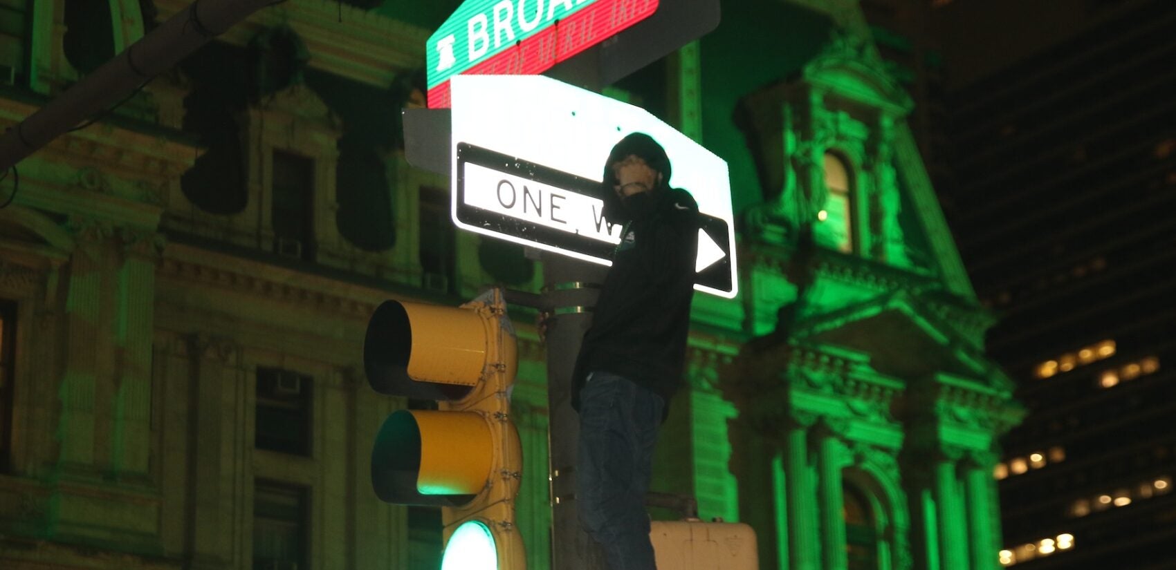 A fan climbs a pole after the Eagles Super Bowl win