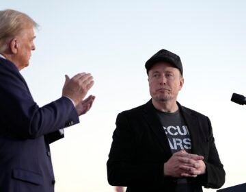 Donald Trump claps next to Elon Musk