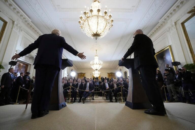 Trump and Netanyahu speaking at a press conference taken from behind them facing the audience