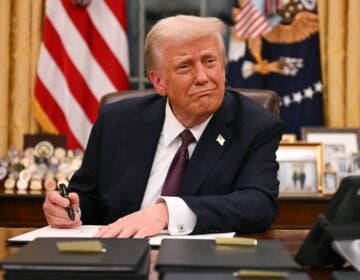 President Trump signs executive orders in the Oval Office of the White House on Jan.20. (JIM WATSON/AFP via Getty Images/AFP)