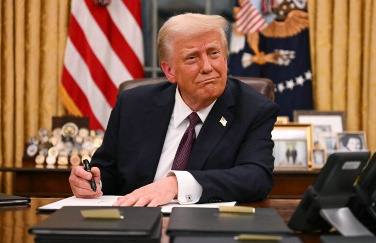 President Trump signs executive orders in the Oval Office of the White House on Jan.20. (JIM WATSON/AFP via Getty Images/AFP)