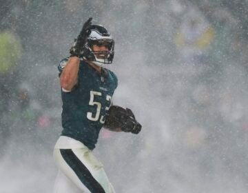 A Philadelphia Eagles player carries the football through falling snow