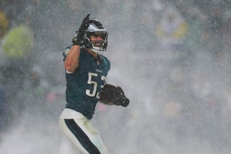 A Philadelphia Eagles player carries the football through falling snow