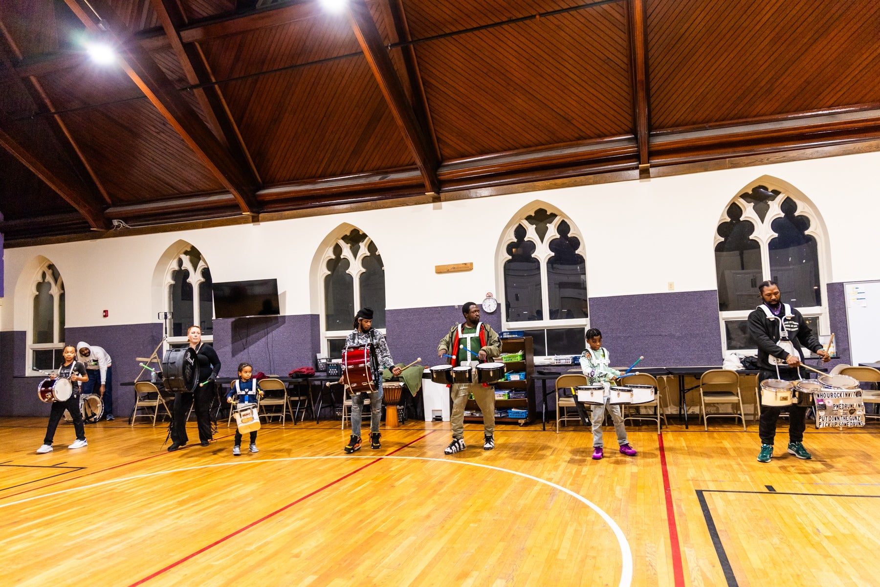 Seven people, including three children, drumming