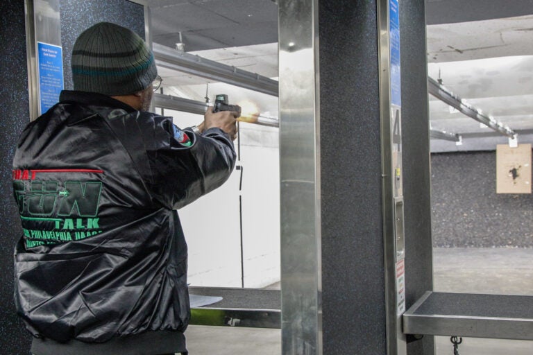 A man aims a gun at a firing range