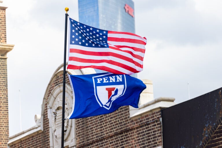 03 26 2025 k paynter upenn file 2025-9 An American flag flying with a Penn flag