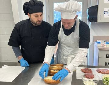 Two people prepare sandwiches at the Burlington County Library