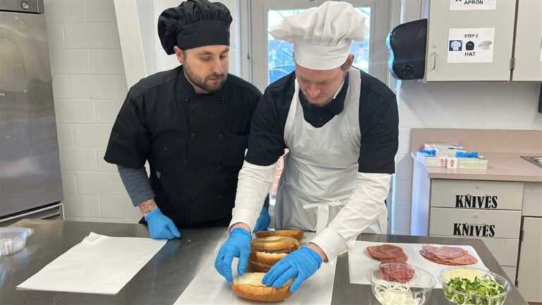 Two people prepare sandwiches at the Burlington County Library