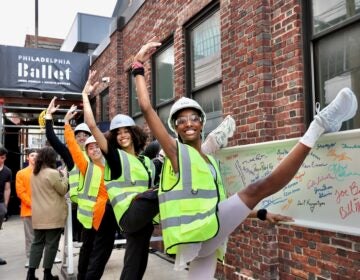 Dancer trainees at the Philadelphia Ballet use a steel girder as a barre during a topping off ceremony for the company's 48,000-square-foot addition to its building on North Broad Street.