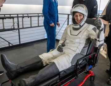 NASA astronaut Suni Williams gives a thumbs-up after being helped out of a SpaceX capsule