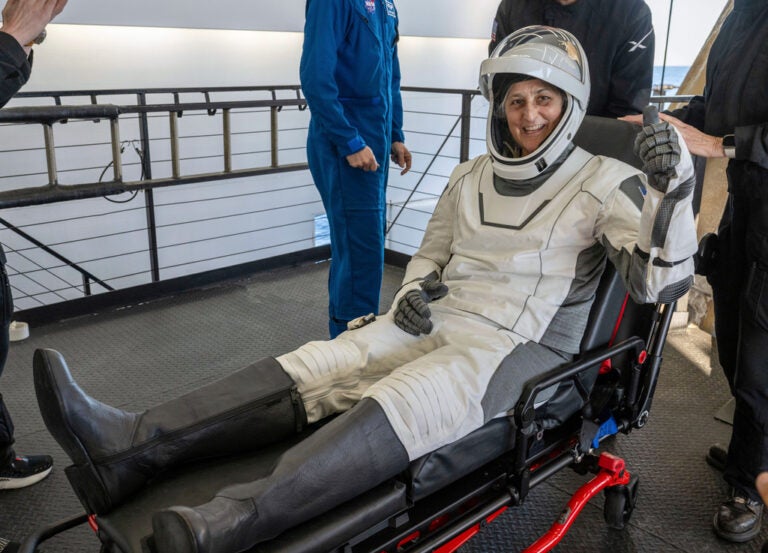 NASA astronaut Suni Williams gives a thumbs-up after being helped out of a SpaceX capsule