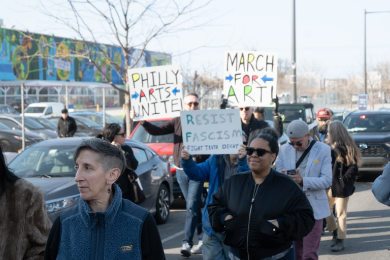 People who work in the Philadelphia culture sector marching with signs reading PHILLY ARTISTS UNITE!, MARCH FOR ART! and RESIST FASCISM FIGHT TRUTH DECAY