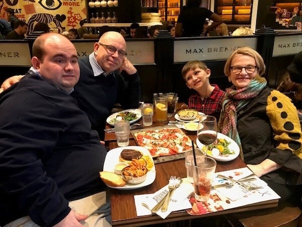 A family poses for photograph while eating at a restaurant