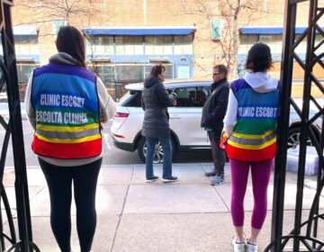 volunteer escorts stand outside a Planned Parenthood