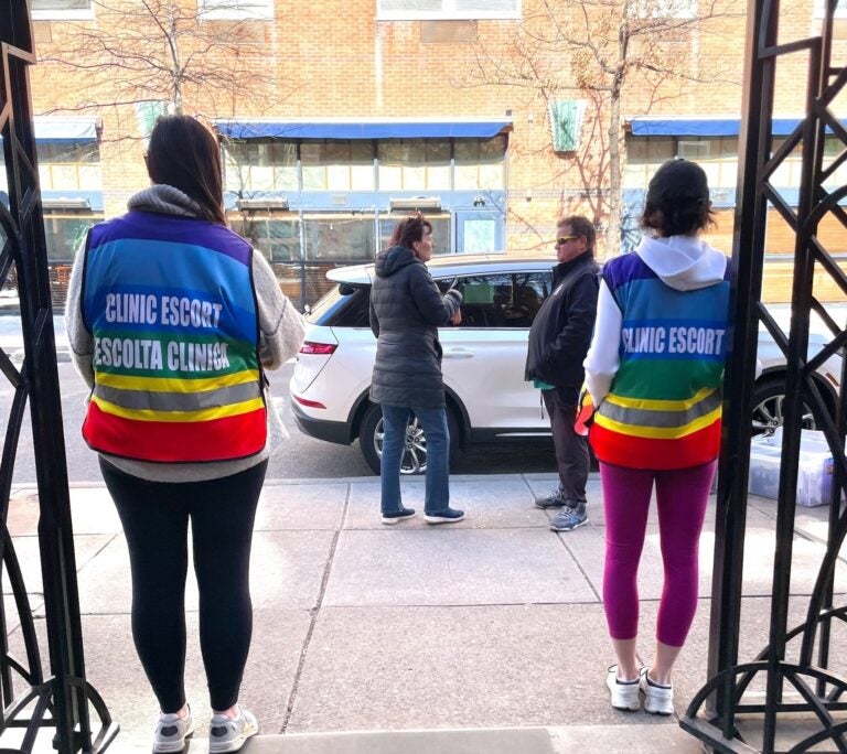 volunteer escorts stand outside a Planned Parenthood