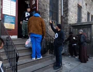 Larry Anderson collects donations outside a building