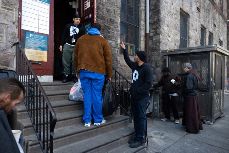 Larry Anderson collects donations outside a building