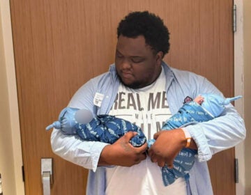 Stanton Cornish-Bell holds his newborn twin sons