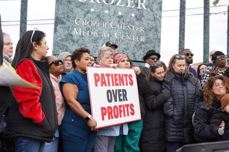 Crozer Health staff protesting with a sign reading PATIENTS OVER PROFITS