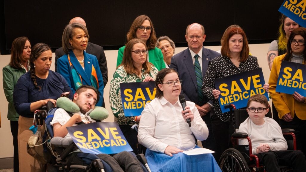 Caroline King speaking into a microphone at the press conference