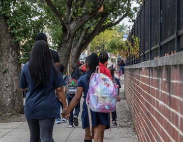 Parents walking their kids kids to Philadelphia's Guion S. Bluford Elementary on the first day of school, September 5, 2023.