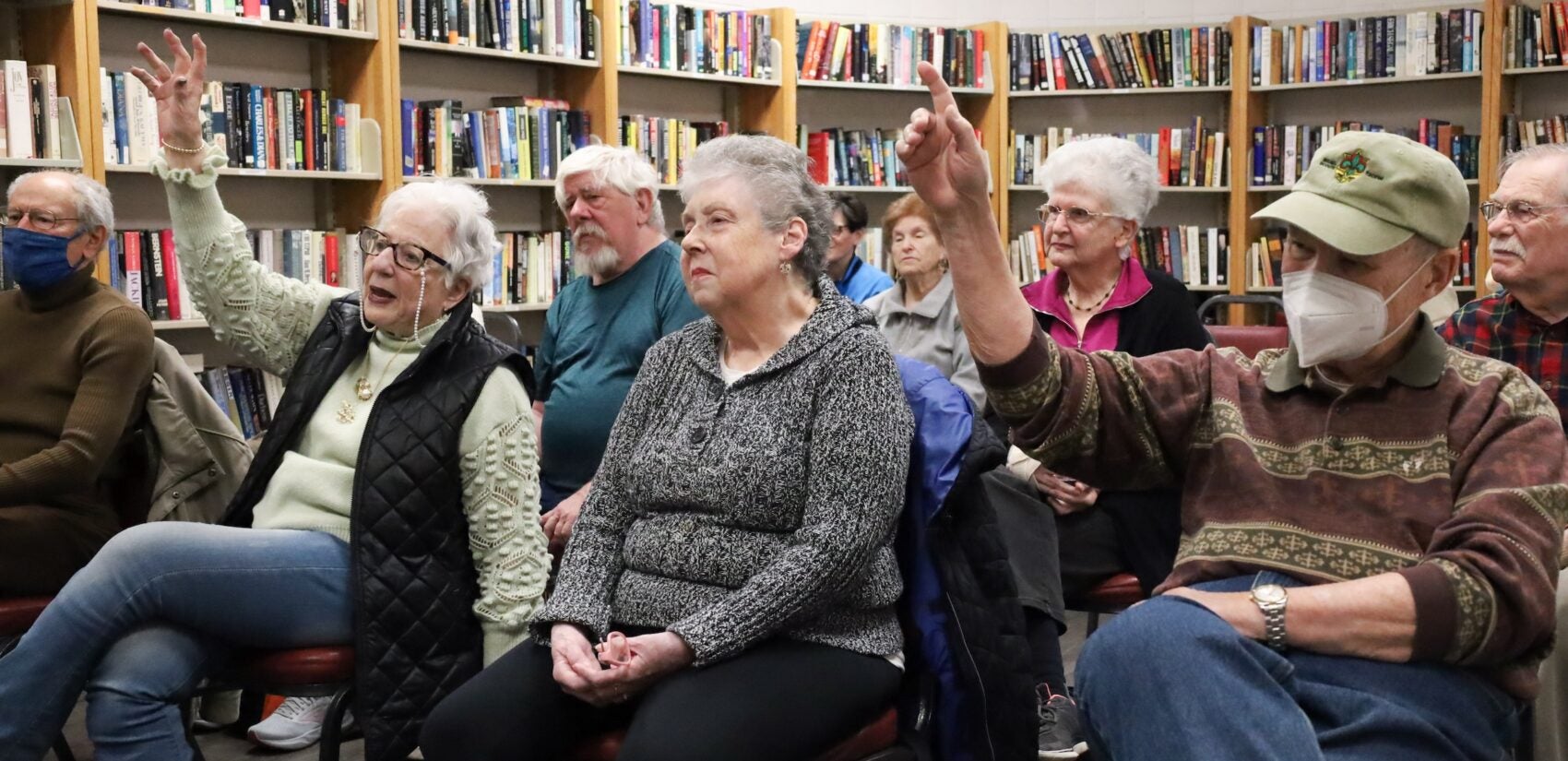 Members of KleinLife in Northeast Philadelphia answer trivia questions in a small library at the community center on March 4, 2025.