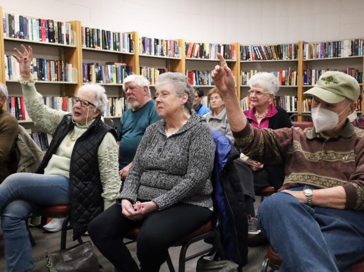 Members of KleinLife in Northeast Philadelphia answer trivia questions in a small library at the community center on March 4, 2025.