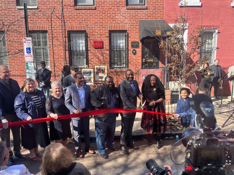 Several dignitaries cut a red ribbon outside the The Marian Anderson Historical Society & Museum in South Philadelphia