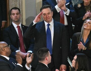 Elon Musk giving a salute to President Trump