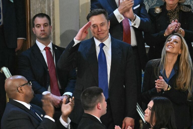 Elon Musk giving a salute to President Trump