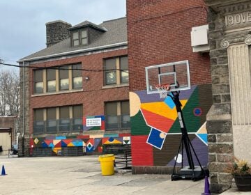 Overbrook's concert schoolyard with a basketball goal