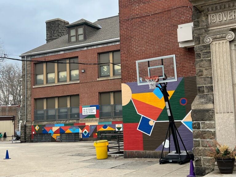 Overbrook's concert schoolyard with a basketball goal