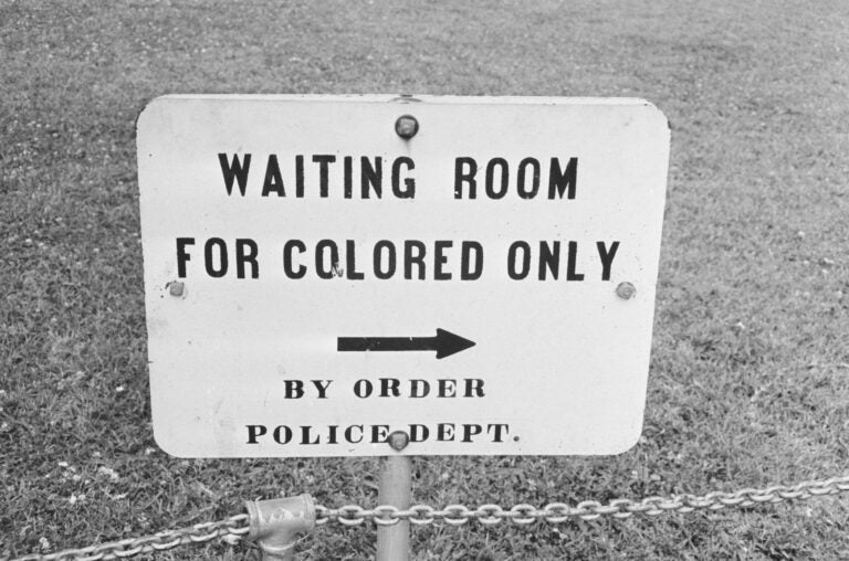 A sign says 'Waiting room for colored only'